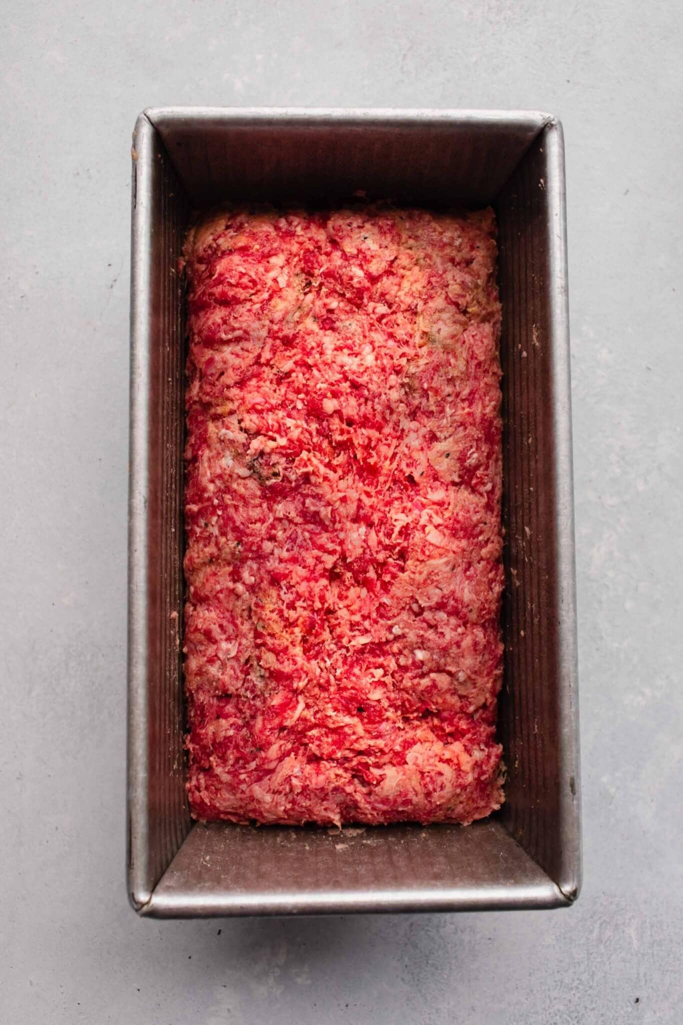 Unbaked meatloaf in pan.
