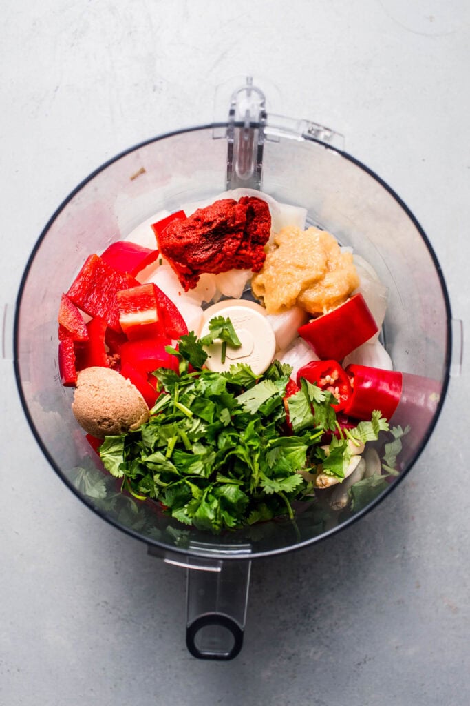 Aromatics added to food processor bowl.