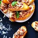 These Lasagna Crostini are a perfect make ahead party appetizer. The Italian meat sauce, creamy ricotta and melty mozzarella cheese are irresistible. Pair them with Chianti for a delicious treat! | platingsandpairings.com