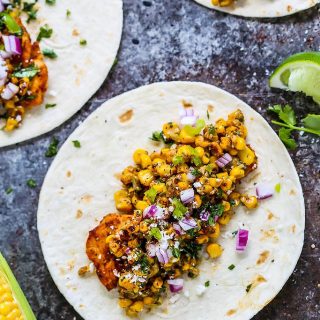 These Mexican Street Corn Chicken Tacos put a fun twist on elotes or grilled Mexican corn on the cob that's slathered in a tangy cream sauce and sprinkled with chili powder. Plus, they come together in just 20 minutes! | platingsandpairings.com