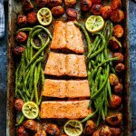 This 5 Ingredient Sheet Pan Salmon is the perfect dinner for busy weeknights! This complete seafood dinner cooks in just 30 minutes and the cleanup is easy too! | platingsandpairings.com