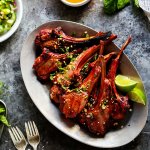 These Lamb Chops with Spicy Peanut Sauce are perfect for your next BBQ. Rich, smoky grilled lamb pairs perfectly with the creamy, tangy Thai-style spicy peanut sauce. It’s a delicious, quick and easy dinner. | platingsandpairings.com