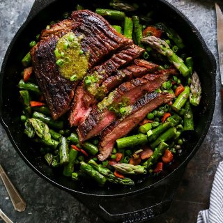 This One-Skillet Steak and Spring Vegetables with Mint Mustard Sauce is an elegant dinner that’s easy enough for weekday entertaining. Steak, peas and asparagus cook up together in just one pan! | platingsandpairings.com