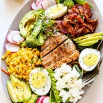 This Summer Chicken Cobb Salad is loaded with veggies and topped with grilled chicken, corn, bacon, avocado, hard boiled egg and goat cheese. | platingsandpairings.com