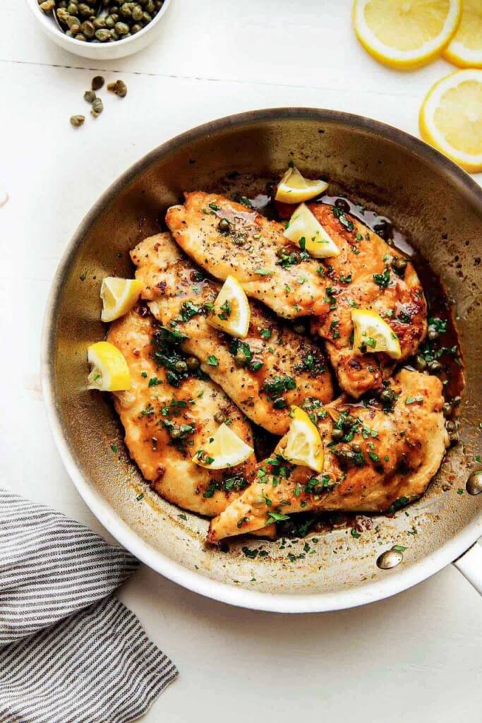 30 Minute Easy Chicken Piccata is perfect for a quick weeknight dinner. The lemon-garlic, butter caper sauce will have you licking your plate. | platingsandpairings.com