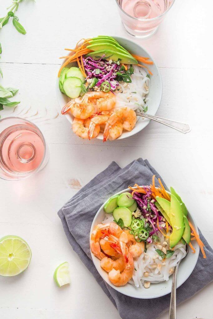 Shrimp Spring Roll Noodle Bowls are easy to assemble at home. Topped with sautéed shrimp, crispy vegetables, fresh mint, basil and cilantro and tossed with a tangy spring roll sauce.