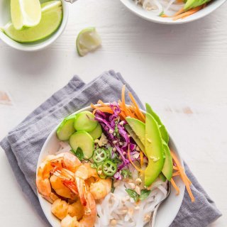Shrimp Spring Roll Noodle Bowls are easy to assemble at home. Topped with sautéed shrimp, crispy vegetables, fresh mint, basil and cilantro and tossed with a tangy spring roll sauce.