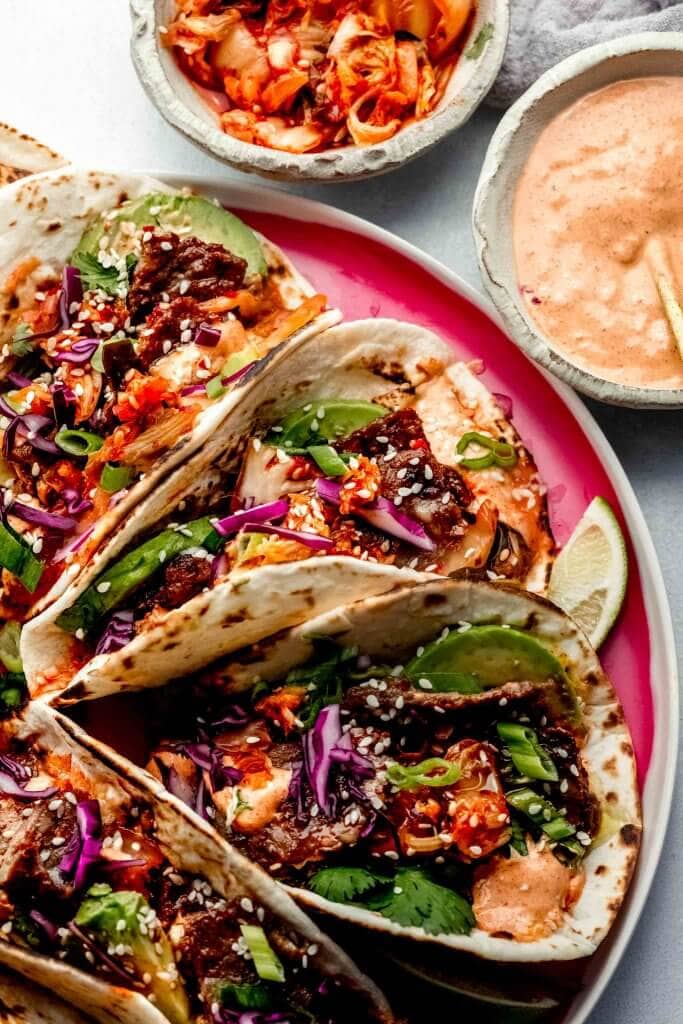 Korean tacos arranged on plate.