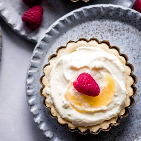 Overhead close up of Lemon Tartlet topped with raspberry.