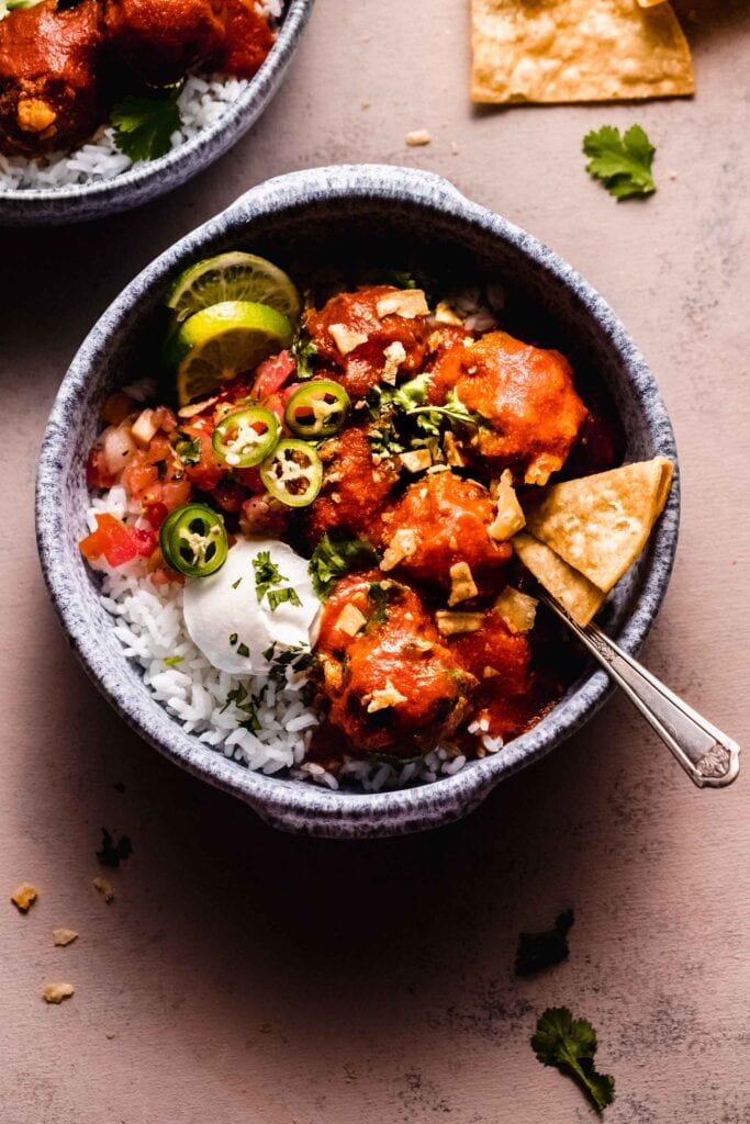 Overhead shot of albondigas in bowl served over rice.