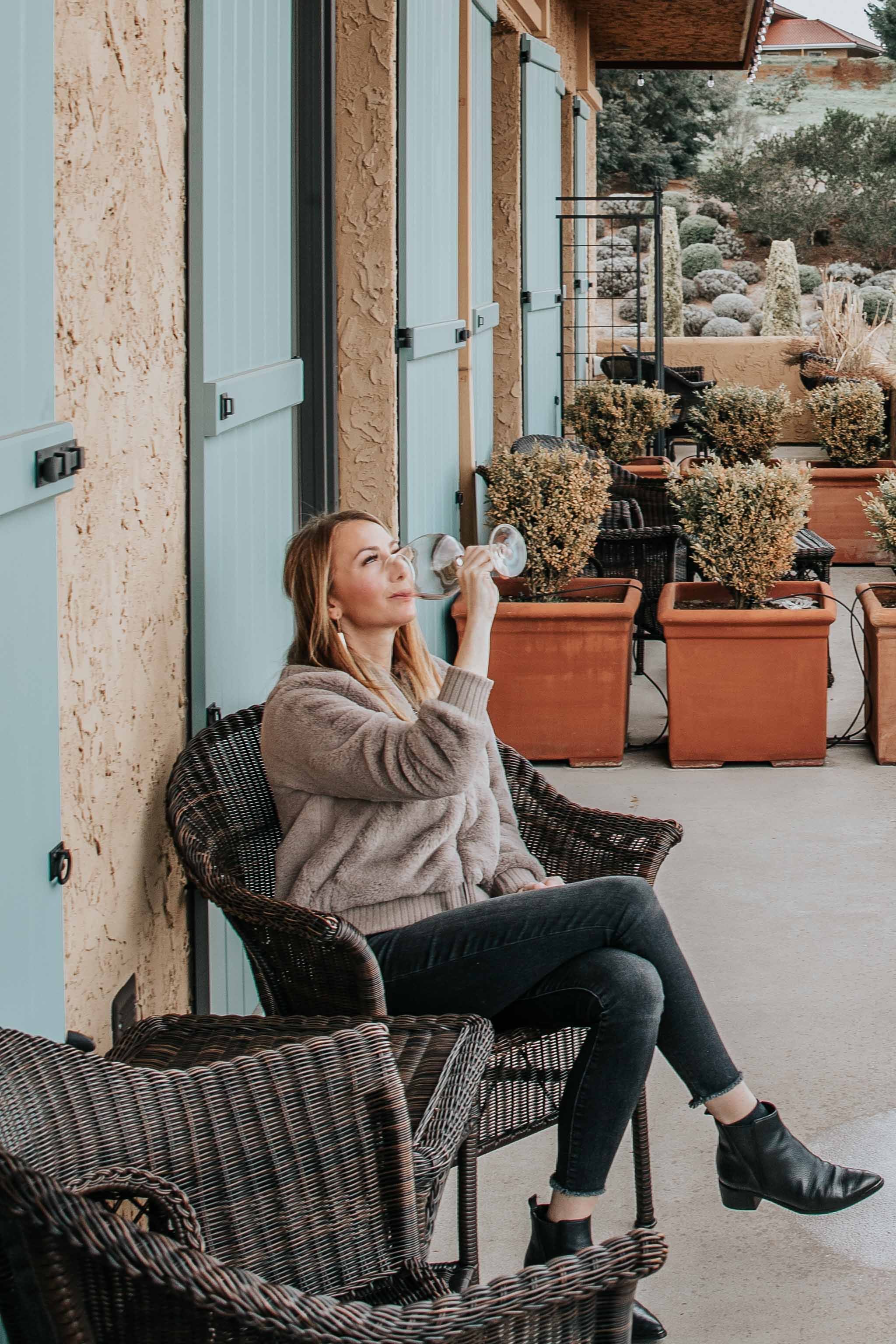 Erin drinking wine on patio at Black Walnut Inn