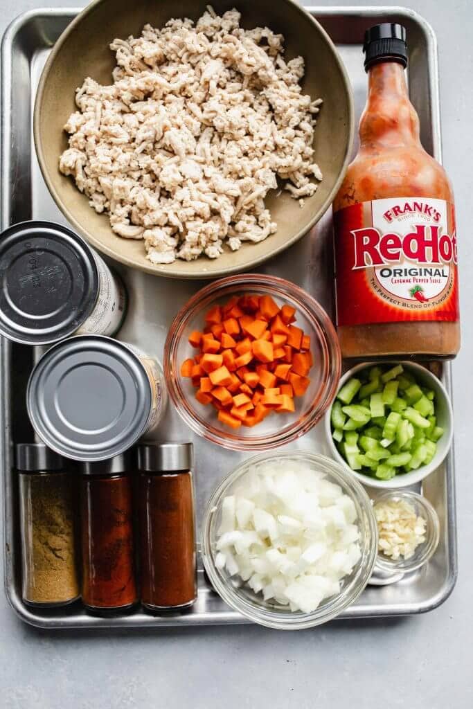 Ingredients for buffalo chicken chili on counter.