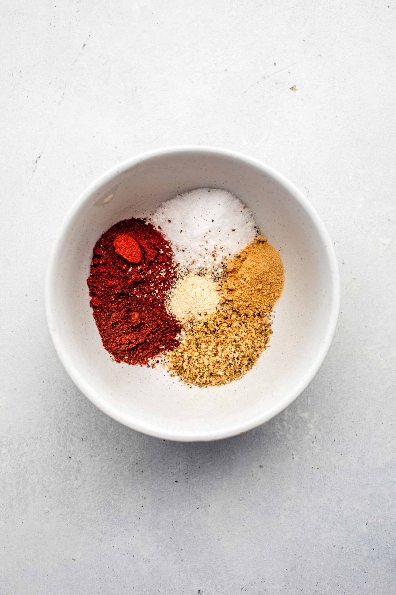 Spices in small bowl before combining for easy roasted chicken.