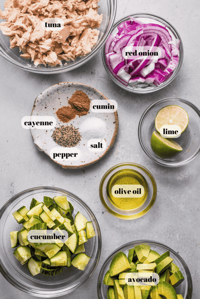 Ingredients for tuna avocado salad labeled on counter.