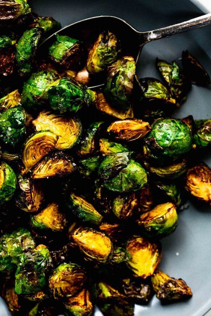 Over head close up of bowl of air fried brussels sprouts.