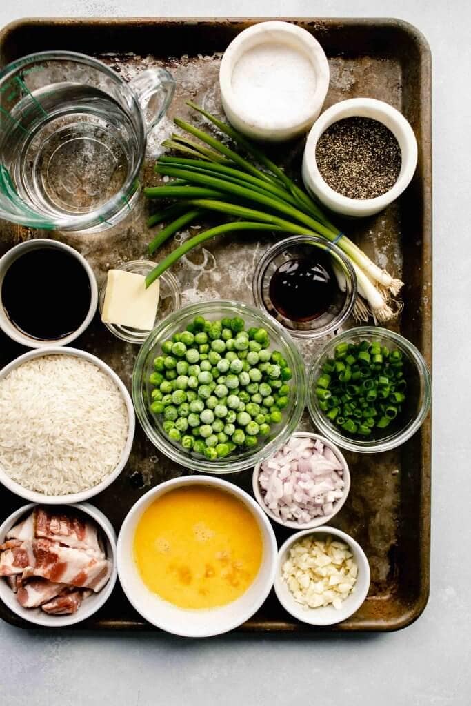 Ingredients needed for fried rice laid out on baking sheet.