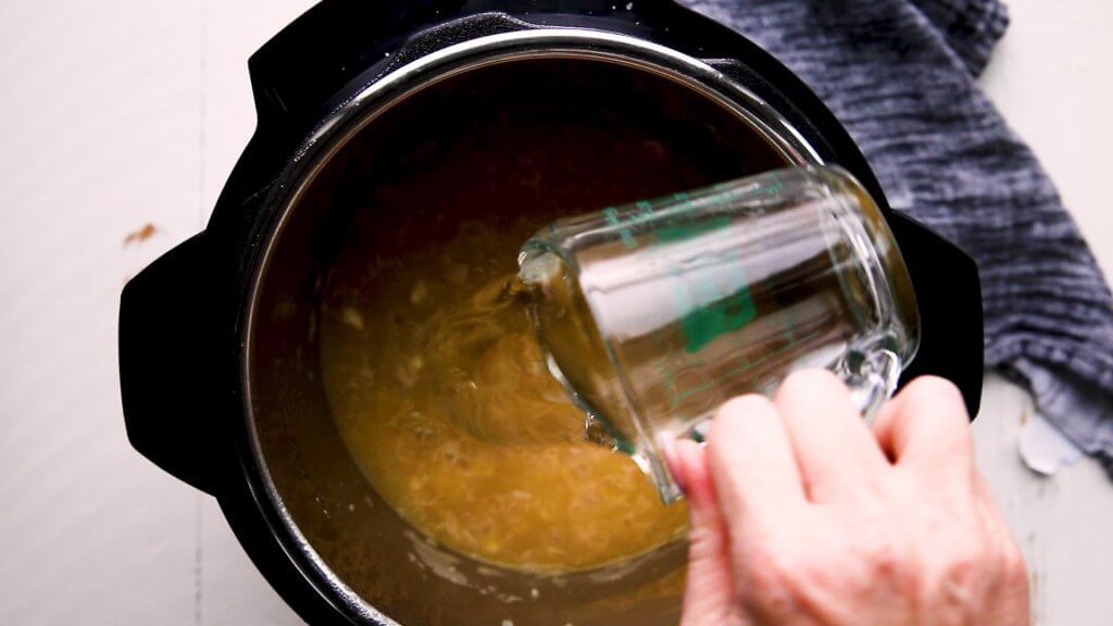 Wine being added to instant pot.