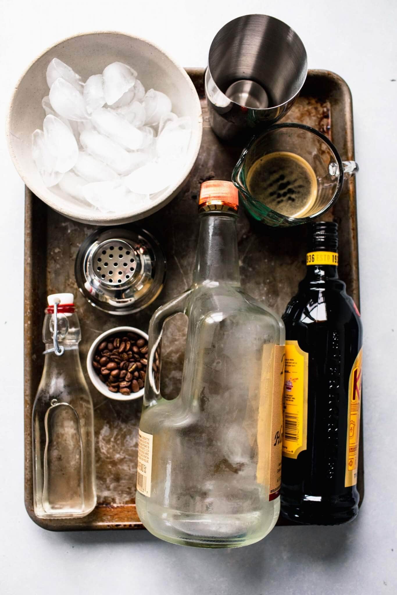Ingredients for espresso martini laid out on tray.