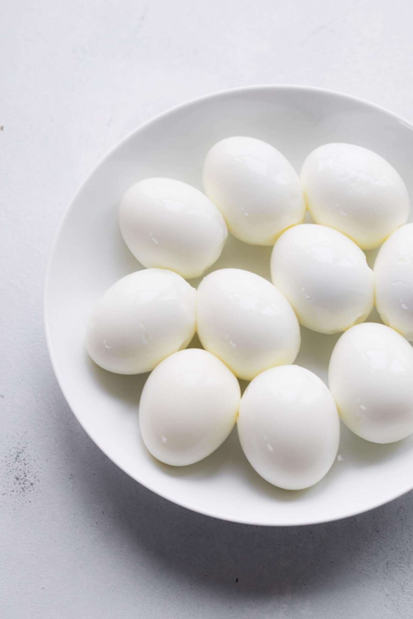 Bowl of peeled hard boiled eggs.