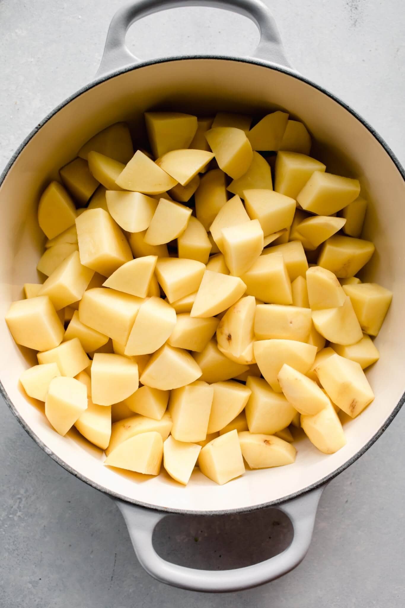 Cubed potatoes in dutch oven before boiling.