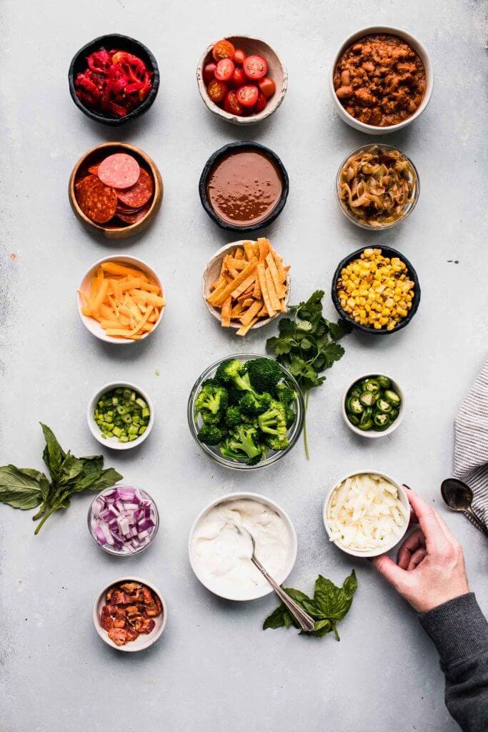 Toppings for baked potato bar on counter. 