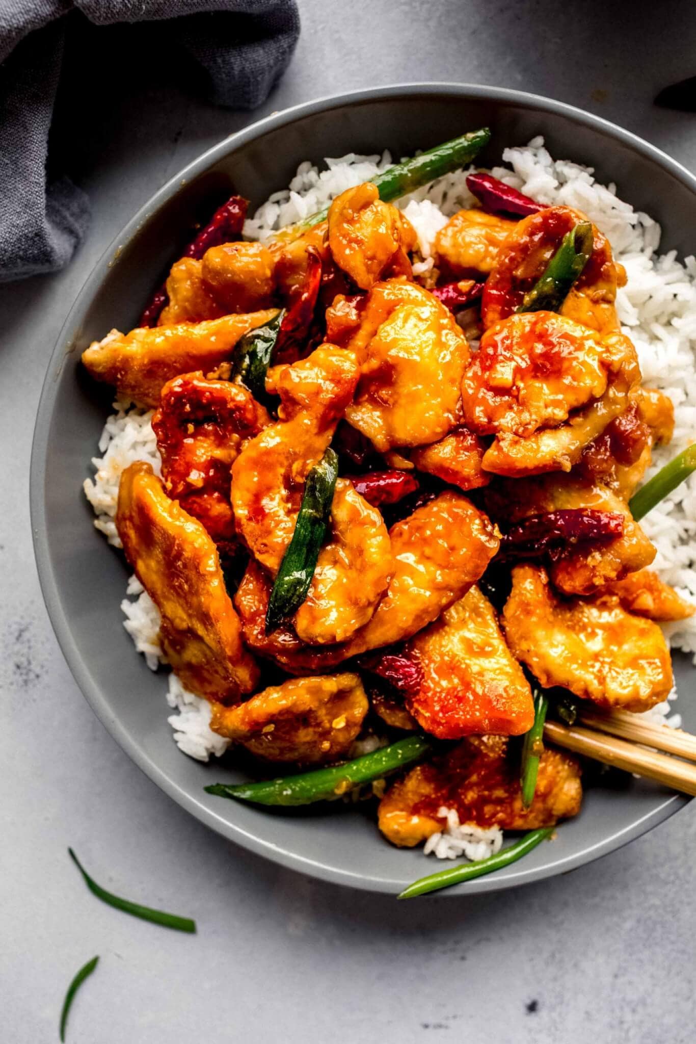 Overhead shot of mongolian chicken in grey bowl with rice.