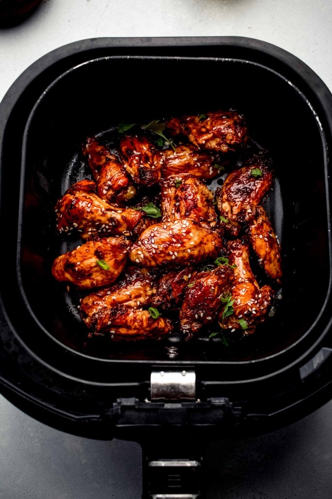 Chinese chicken wings in air fryer basket.