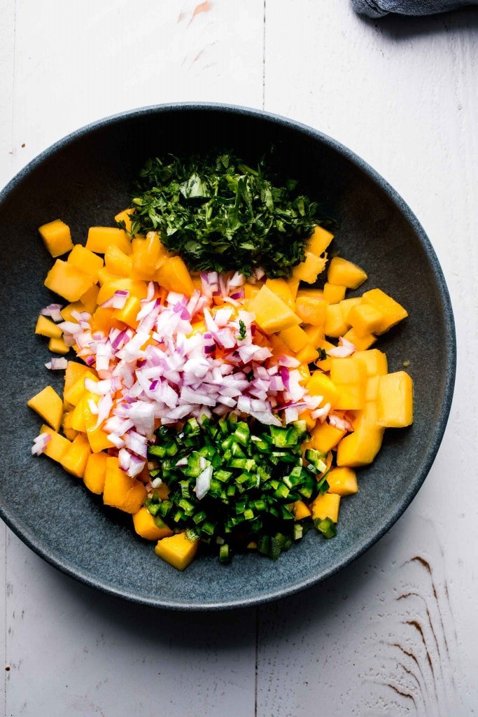 Ingredients for mango salsa in bowl.