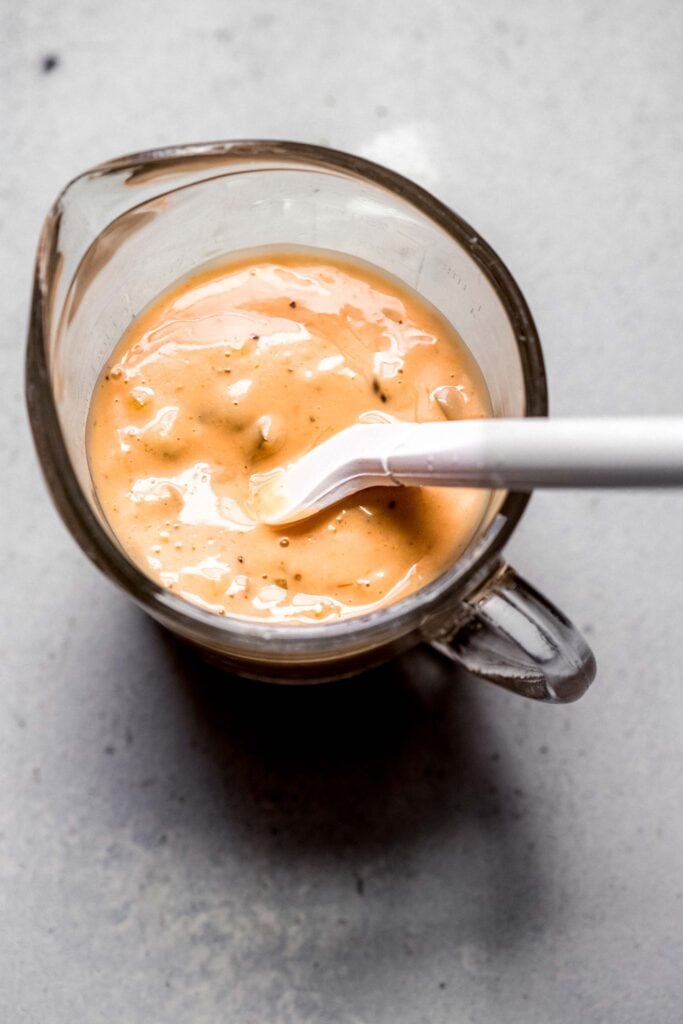 In N Out Sauce in measuring cup with small spatula.