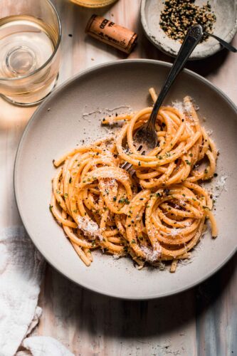 Miso pasta in bowl next to small bowl of furikake.