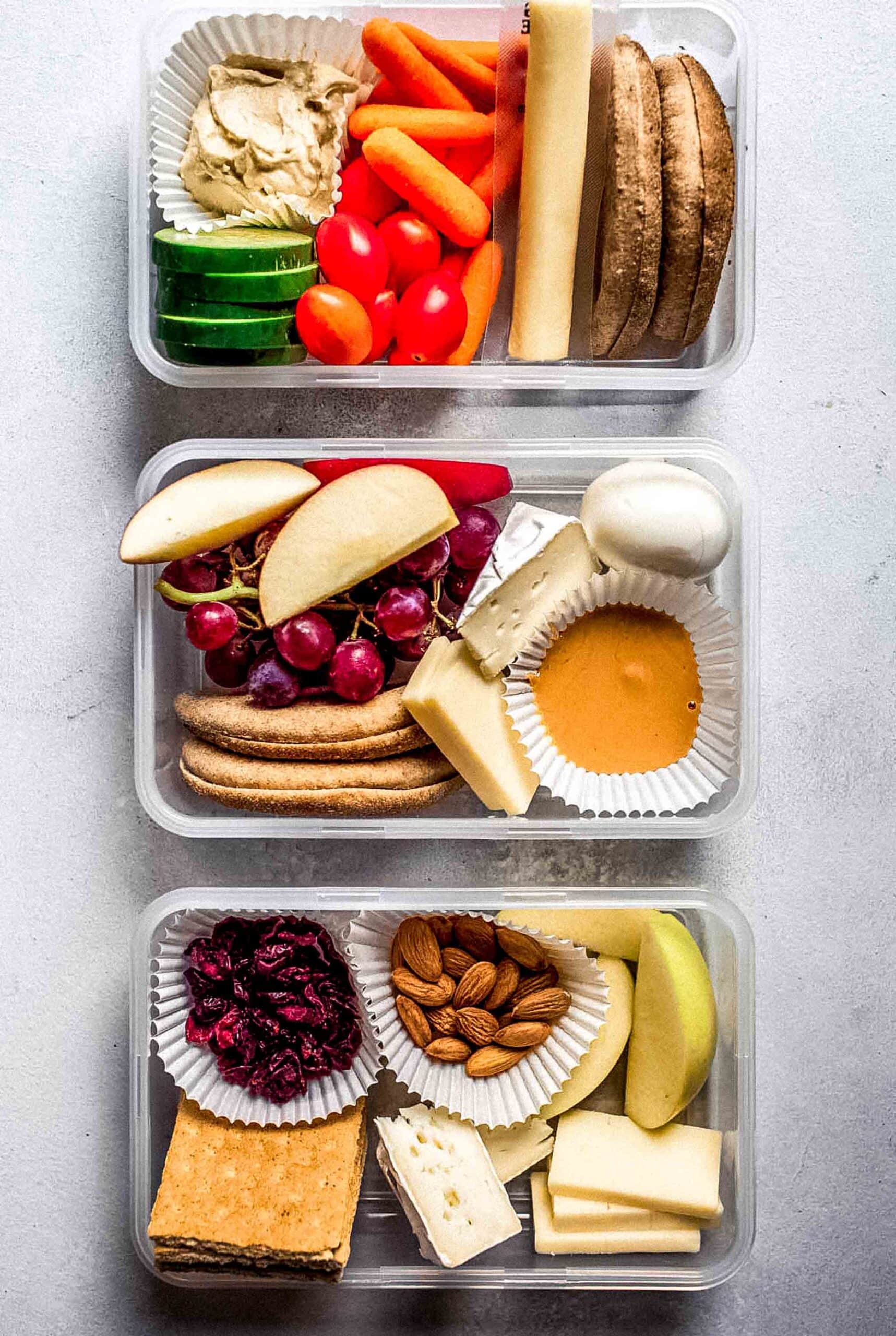 Three adult lunchables in small tupperwares.