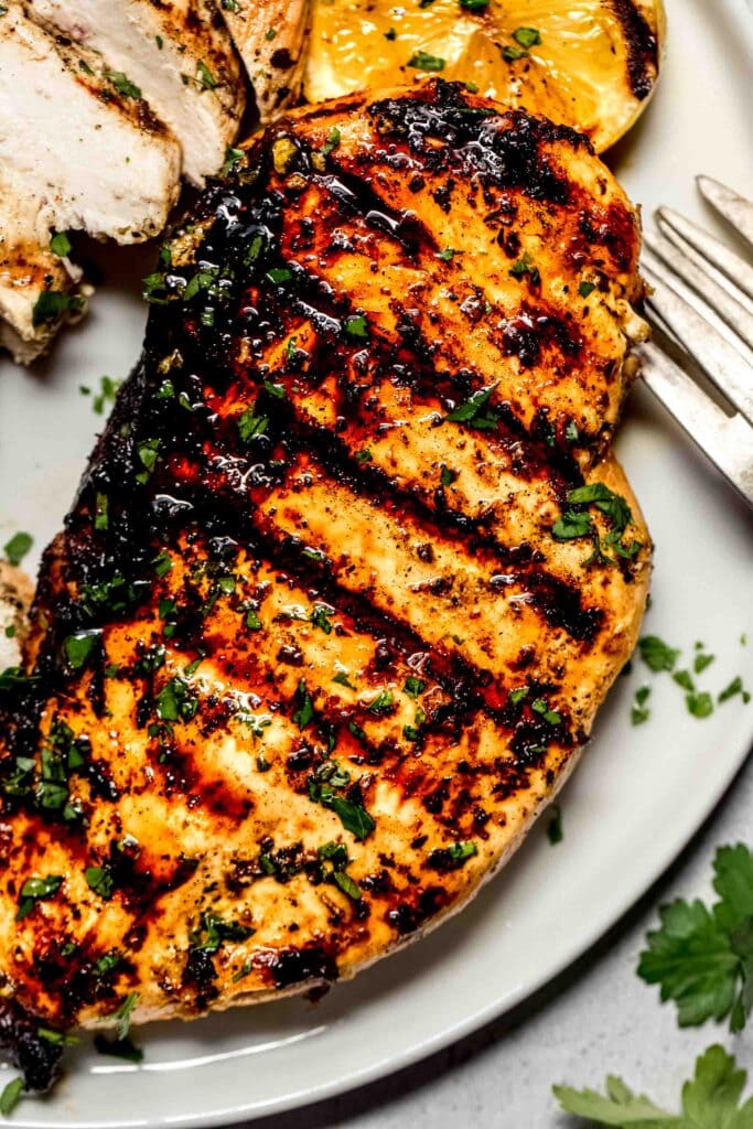 Close up of chicken breast with grill marks.