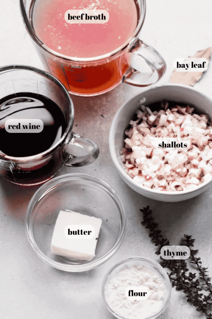 Ingredients for red wine jus labeled on counter.