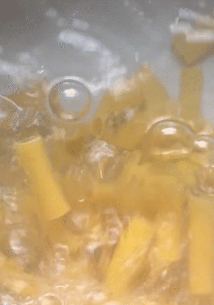 rigatoni cooking in water.