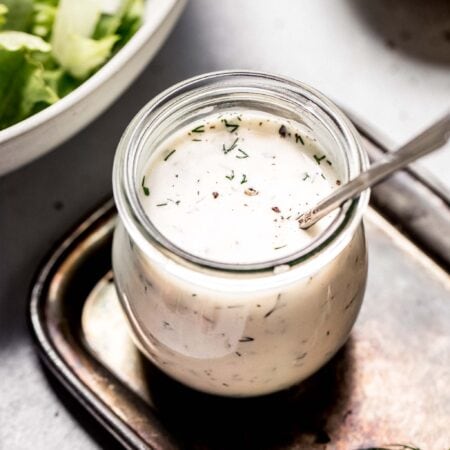 Side view of jar of creamy greek yogurt salad dressing