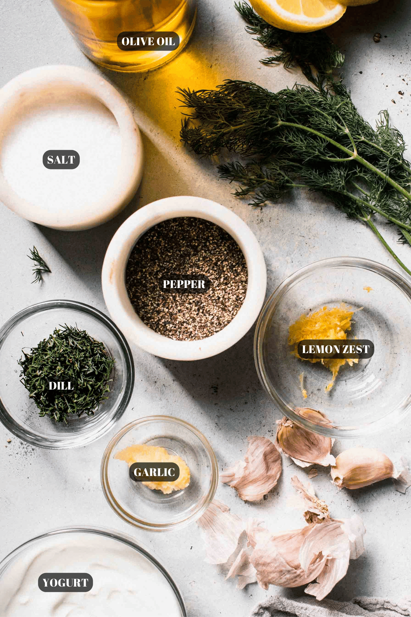 Ingredients for yogurt dill sauce labeled on counter.