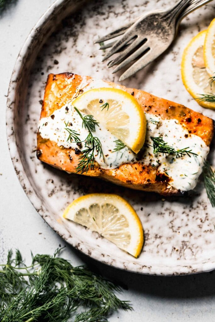 Salmon filet drizzled with creamy dill sauce.
