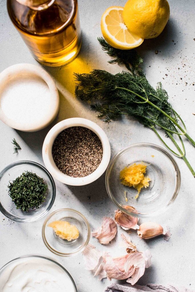 Ingredients for yogurt dill sauce for salmon on counter.