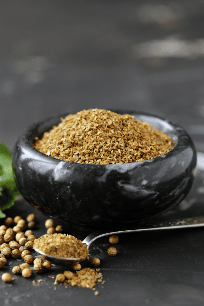 Ground coriander in small bowl.