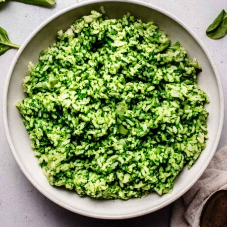 Spinach rice in white serving bowl.