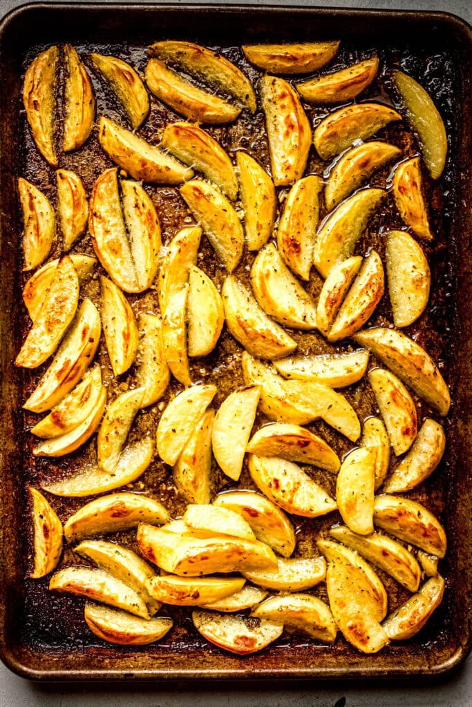 Finished roasted potatoes on baking sheet.