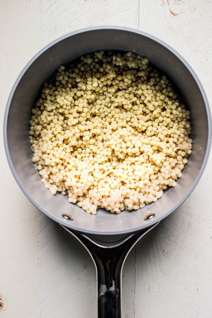 Cooked israeli couscous in pot.
