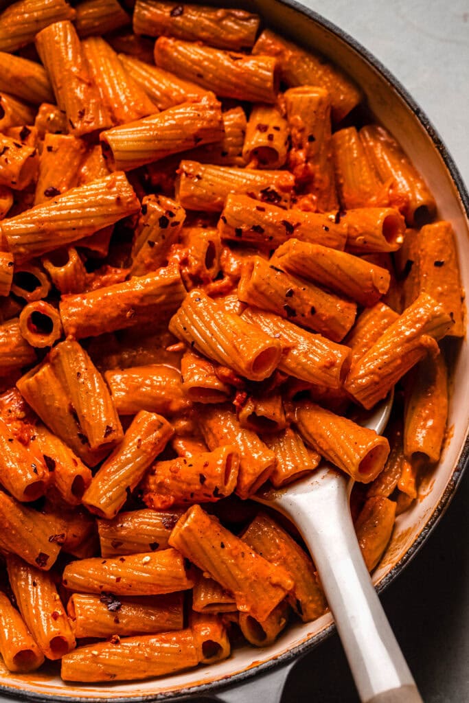 Close up of finished cajun spicy pasta in skillet.