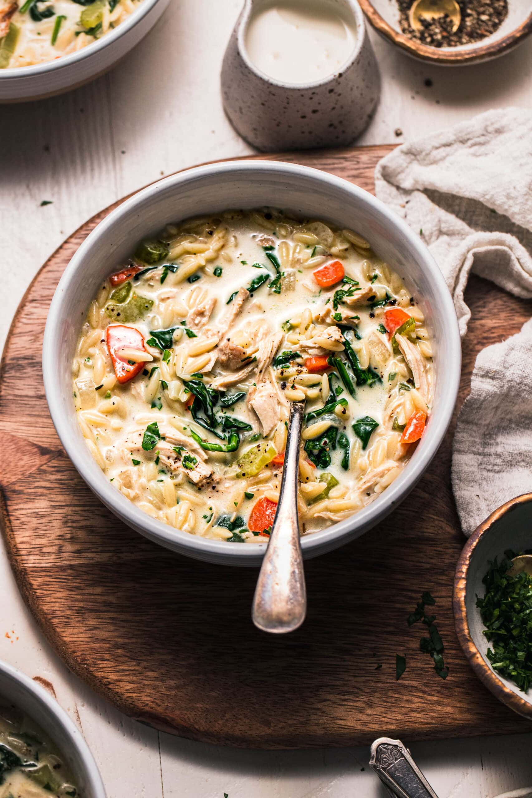 Side angle view of creamy orzo chicken soup.