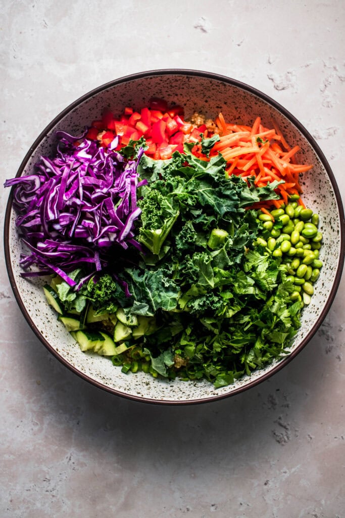 Thai quinoa salad ingredients in bowl before tossing.