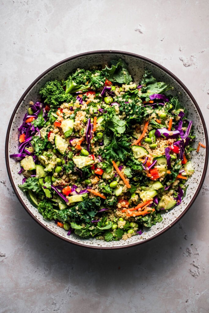 Thai quinoa salad tossed together in bowl.