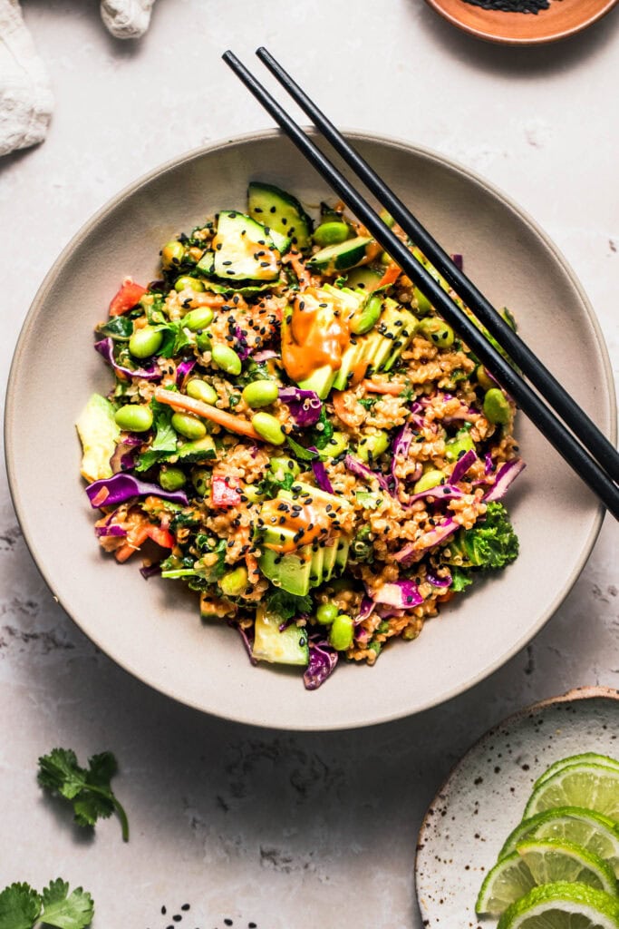 Thai quinoa salad in serving bowl with chopsticks.