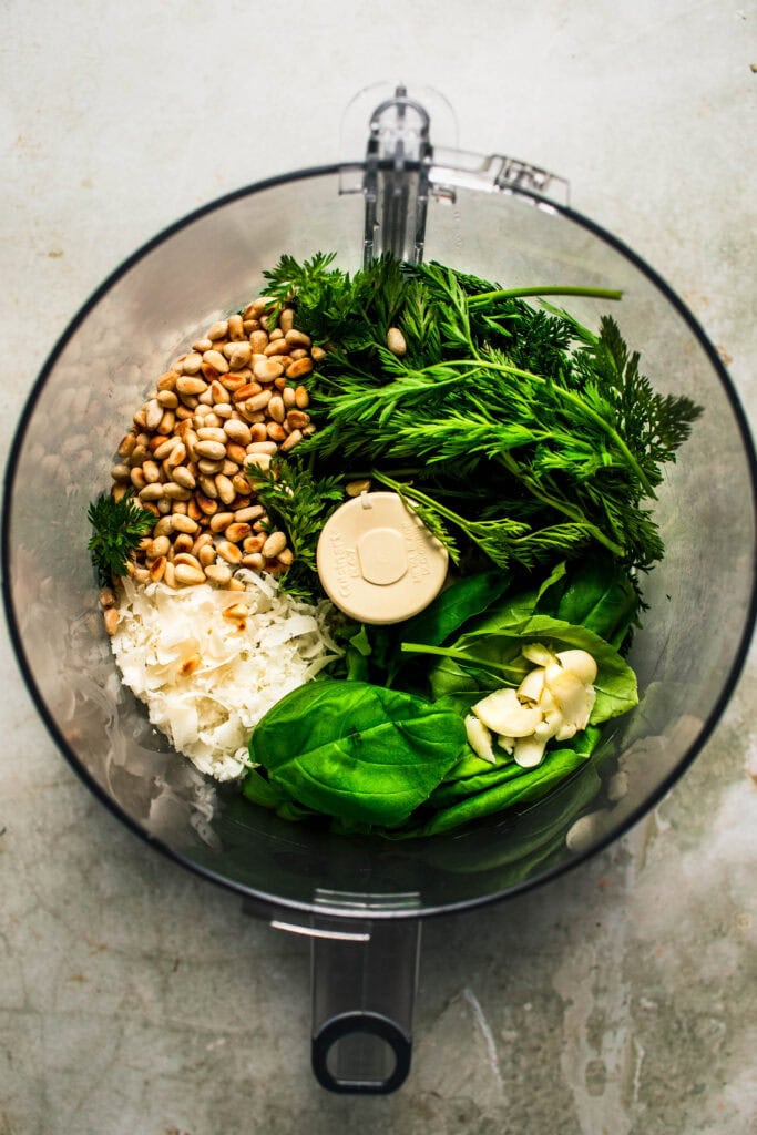 Carrot Top pesto ingredients in food processor bowl.