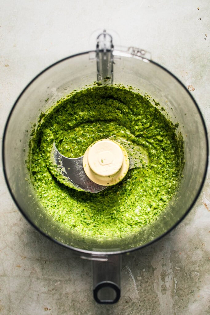 Finished carrot top pesto in food processor bowl.