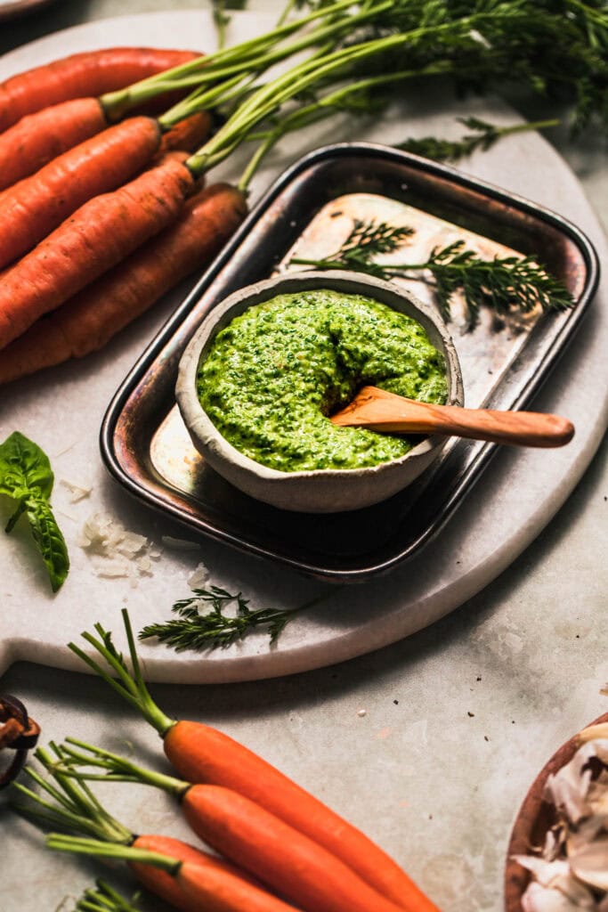 Side view of bowl of carrot tops pesto.